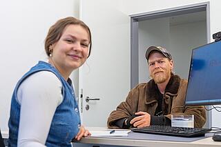 Mitarbeiterin und Bewohner am Tisch