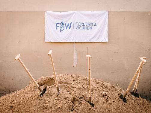 Spaten stecken in einem Berg aus Erde 